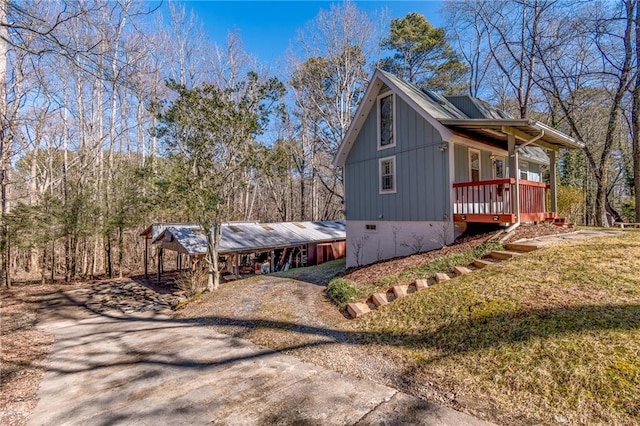 view of side of property with a lawn and a porch