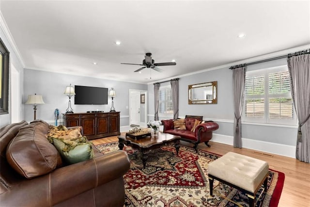 living room with baseboards, light wood finished floors, recessed lighting, and crown molding