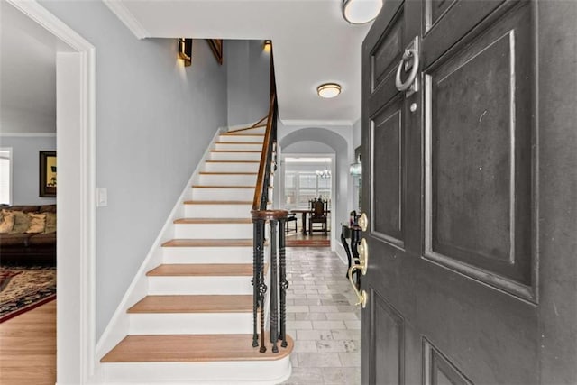 669 Dixon Dr, Gainesville, GA 30501 - foyer entrance with crown molding, stairway, arched walkways, and baseboards