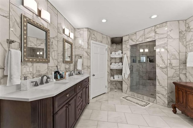 bathroom featuring recessed lighting, a sink, tile walls, double vanity, and a stall shower