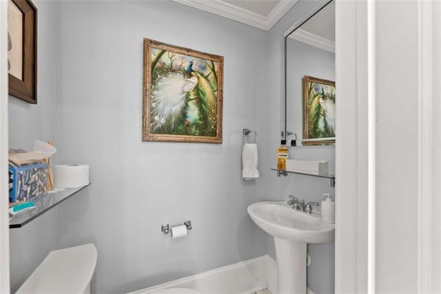 bathroom featuring ornamental molding, a sink, and toilet