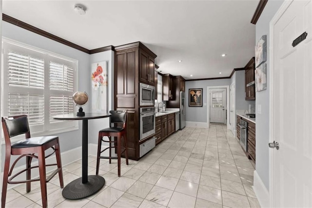 669 Dixon Dr, Gainesville, GA 30501 - kitchen featuring appliances with stainless steel finishes, baseboards, light countertops, dark brown cabinets, and crown molding