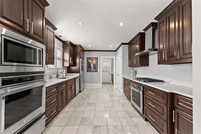 669 Dixon Dr, Gainesville, GA 30501 - kitchen featuring appliances with stainless steel finishes, wall chimney exhaust hood, baseboards, a sink, and crown molding