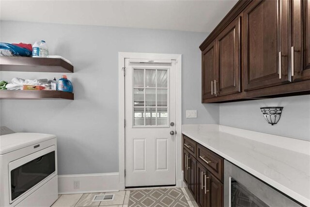 laundry area with visible vents, washer / clothes dryer, cabinet space, and baseboards