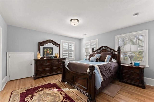 bedroom with light wood-style floors and baseboards