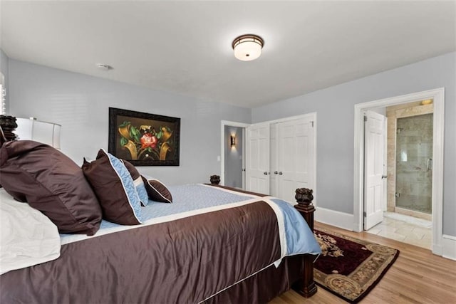 669 Dixon Dr, Gainesville, GA 30501 - bedroom with connected bathroom, wood finished floors, baseboards, and a closet