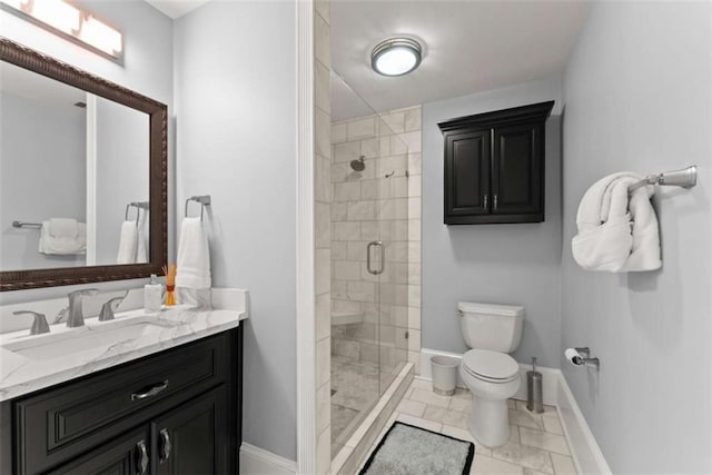 full bathroom featuring baseboards, toilet, a shower stall, and vanity