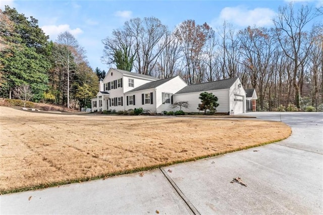 669 Dixon Dr, Gainesville, GA 30501 - view of front of home featuring concrete driveway, a garage, and view of wooded area