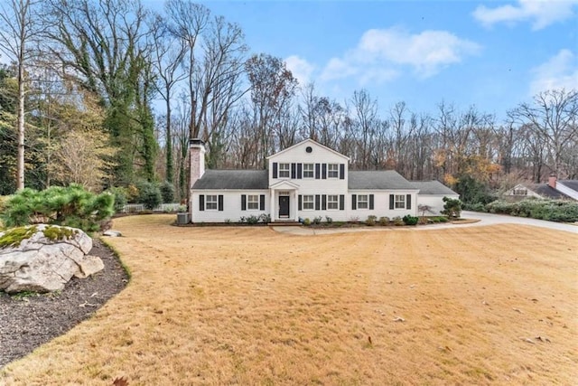 view of front of property with a front yard and a chimney