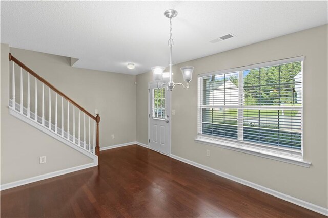 entrance foyer featuring hardwood / wood-style flooring and a chandelier