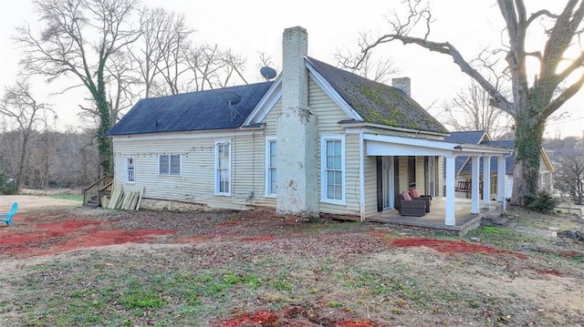 rear view of house featuring a chimney