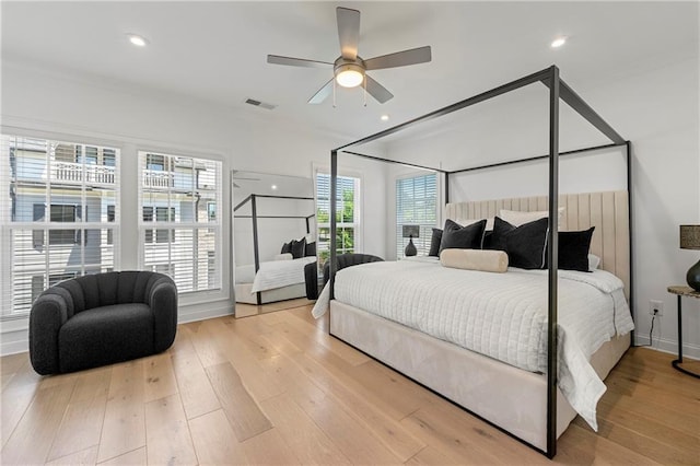 bedroom featuring visible vents, wood finished floors, and crown molding