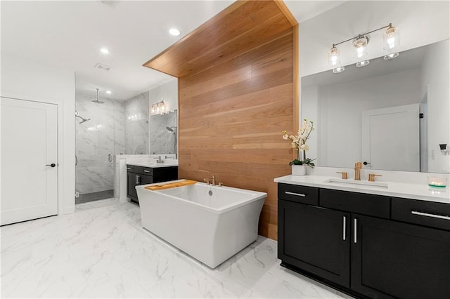 full bath with a marble finish shower, marble finish floor, a freestanding bath, and vanity