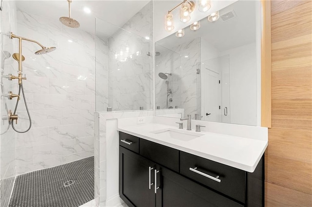 full bathroom with vanity, visible vents, and a marble finish shower