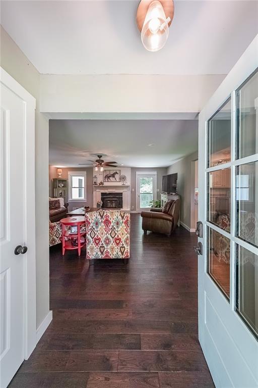 527 Gaddis Rd, Canton, GA 30115 - living room with dark wood-type flooring, a fireplace, and a ceiling fan