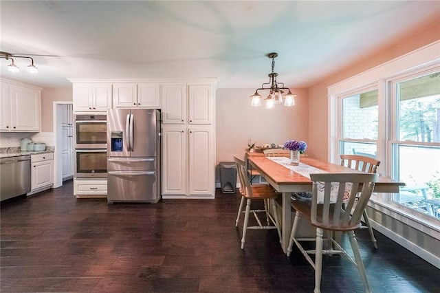 527 Gaddis Rd, Canton, GA 30115 - dining space with dark wood-style flooring and a chandelier
