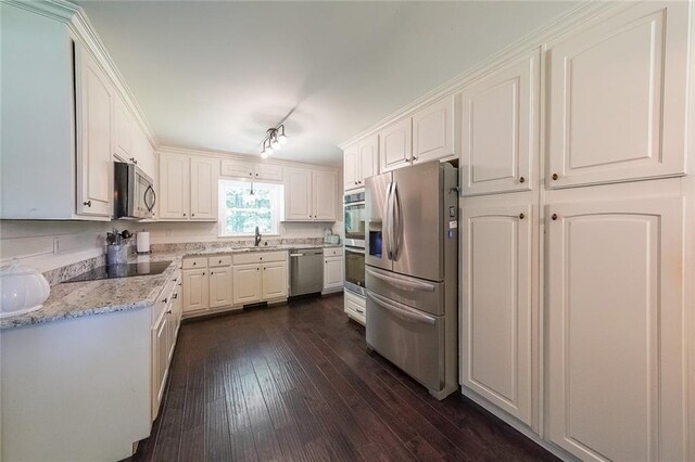 527 Gaddis Rd, Canton, GA 30115 - kitchen featuring appliances with stainless steel finishes, dark wood finished floors, white cabinetry, and light stone counters