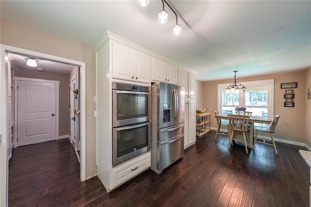 527 Gaddis Rd, Canton, GA 30115 - kitchen featuring appliances with stainless steel finishes, white cabinets, dark wood-type flooring, a chandelier, and hanging light fixtures