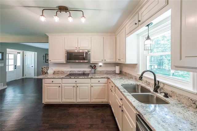527 Gaddis Rd, Canton, GA 30115 - kitchen with stainless steel microwave, black electric stovetop, light stone countertops, and white cabinets