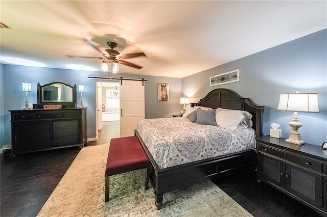 527 Gaddis Rd, Canton, GA 30115 - bedroom with a barn door, dark wood-style flooring, and ceiling fan