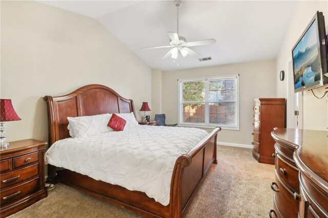 carpeted bedroom with vaulted ceiling and ceiling fan