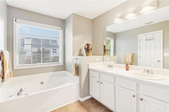 bathroom featuring vanity, a tub, and tile patterned flooring