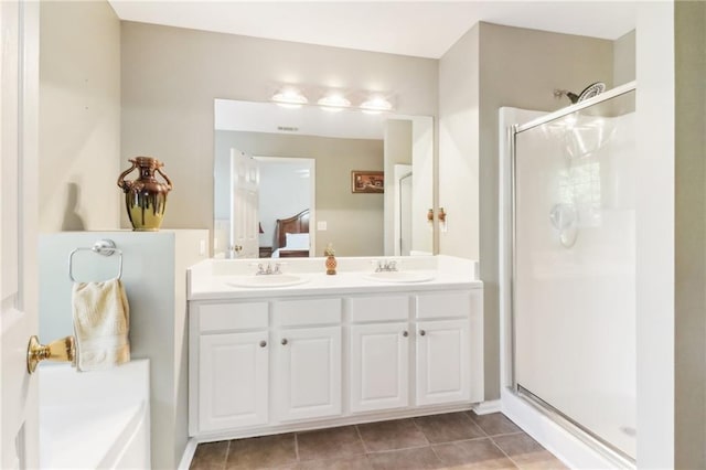 bathroom with vanity, a shower with shower door, and tile patterned flooring