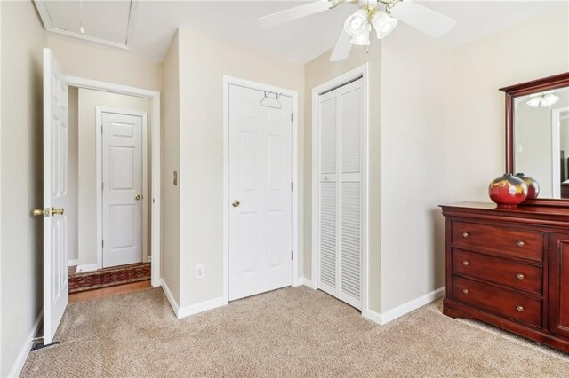 carpeted bedroom with a closet and ceiling fan