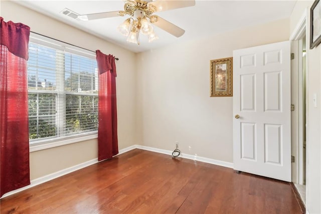 spare room featuring ceiling fan and dark hardwood / wood-style flooring