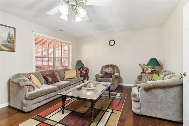 living room featuring ceiling fan and dark hardwood / wood-style flooring