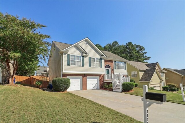 bi-level home featuring a front yard and a garage