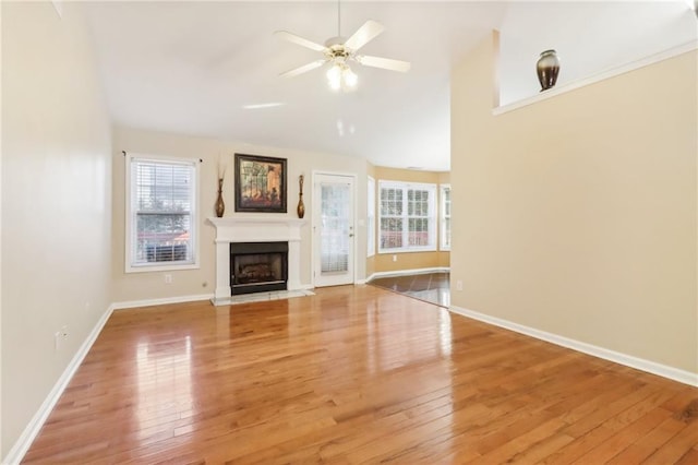 unfurnished living room with light hardwood / wood-style flooring and ceiling fan