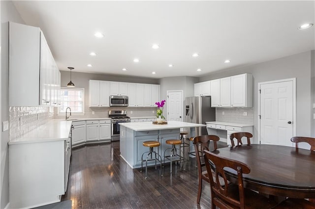 141 Ennisbrook Dr SE, Smyrna, GA 30082 - kitchen with stainless steel appliances, a sink, a center island, white cabinets, and decorative backsplash
