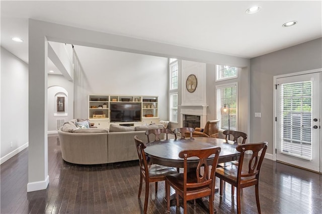 141 Ennisbrook Dr SE, Smyrna, GA 30082 - dining space featuring a fireplace, dark wood-style flooring, baseboards, and recessed lighting
