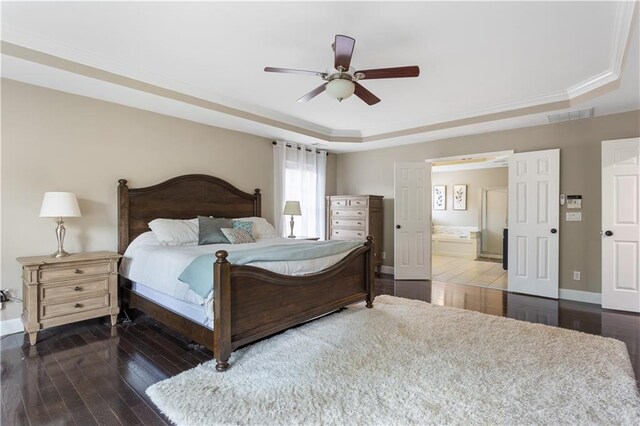 141 Ennisbrook Dr SE, Smyrna, GA 30082 - bedroom with a raised ceiling, hardwood / wood-style flooring, ensuite bathroom, baseboards, and a ceiling fan