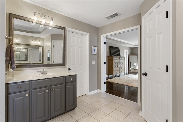 141 Ennisbrook Dr SE, Smyrna, GA 30082 - bathroom featuring vanity, a tray ceiling, tile patterned flooring, baseboards, and ornamental molding
