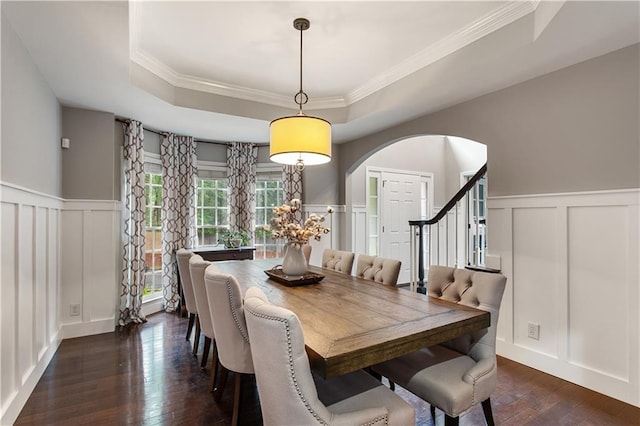 141 Ennisbrook Dr SE, Smyrna, GA 30082 - dining room with a decorative wall, a tray ceiling, arched walkways, dark wood finished floors, and a wainscoted wall