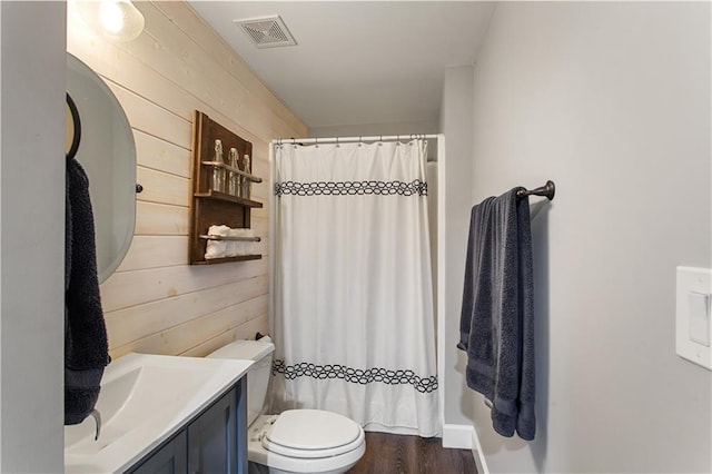 141 Ennisbrook Dr SE, Smyrna, GA 30082 - full bathroom featuring vanity, toilet, wood walls, curtained shower, and wood finished floors