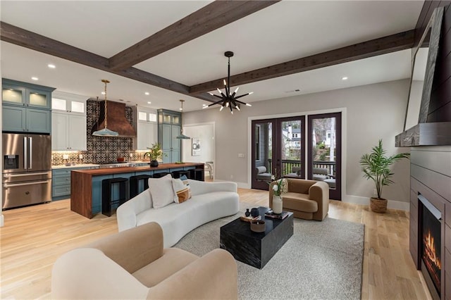662 Timm Valley Rd NE, Atlanta, GA 30305 - living room featuring beam ceiling, light wood finished floors, a large fireplace, baseboards, and recessed lighting