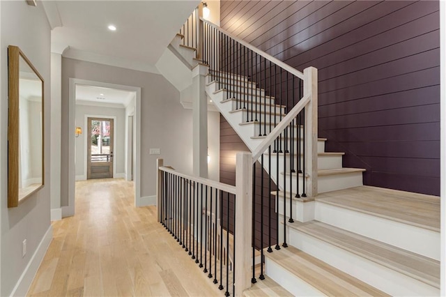 stairs featuring recessed lighting, baseboards, wood finished floors, and ornamental molding