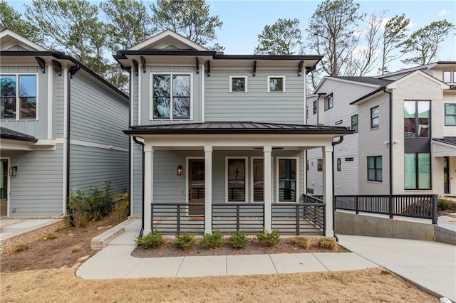 view of front facade featuring covered porch, metal roof, and a standing seam roof