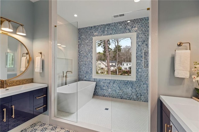 full bath featuring visible vents, vanity, and walk in shower