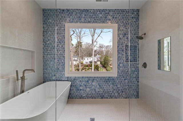 full bath featuring a soaking tub, visible vents, and walk in shower