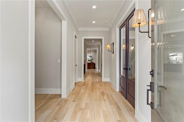 hallway featuring ornamental molding, light wood-type flooring, recessed lighting, and baseboards