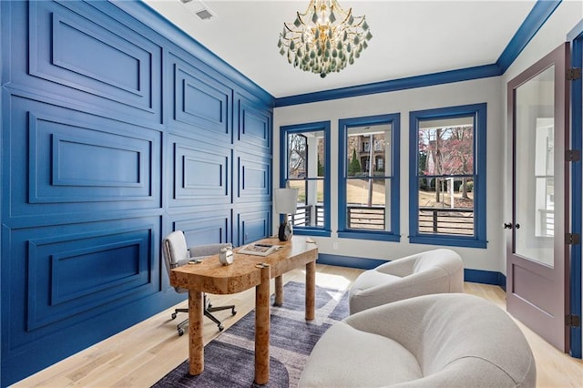 office with visible vents, baseboards, light wood-style flooring, crown molding, and a notable chandelier