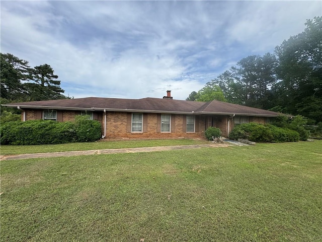 single story home with a front lawn, brick siding, and a chimney
