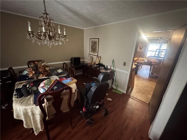 dining space with wood finished floors, crown molding, and a textured ceiling