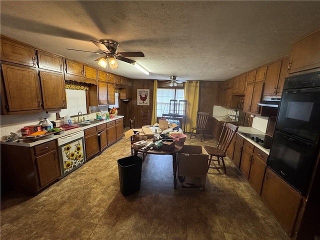 kitchen with black appliances, light countertops, a ceiling fan, a textured ceiling, and a sink