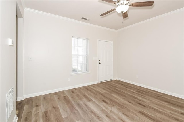 unfurnished room featuring ceiling fan, crown molding, and light wood-type flooring