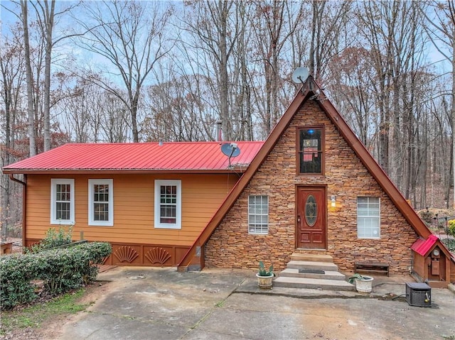 view of front of home featuring central AC unit and a patio area